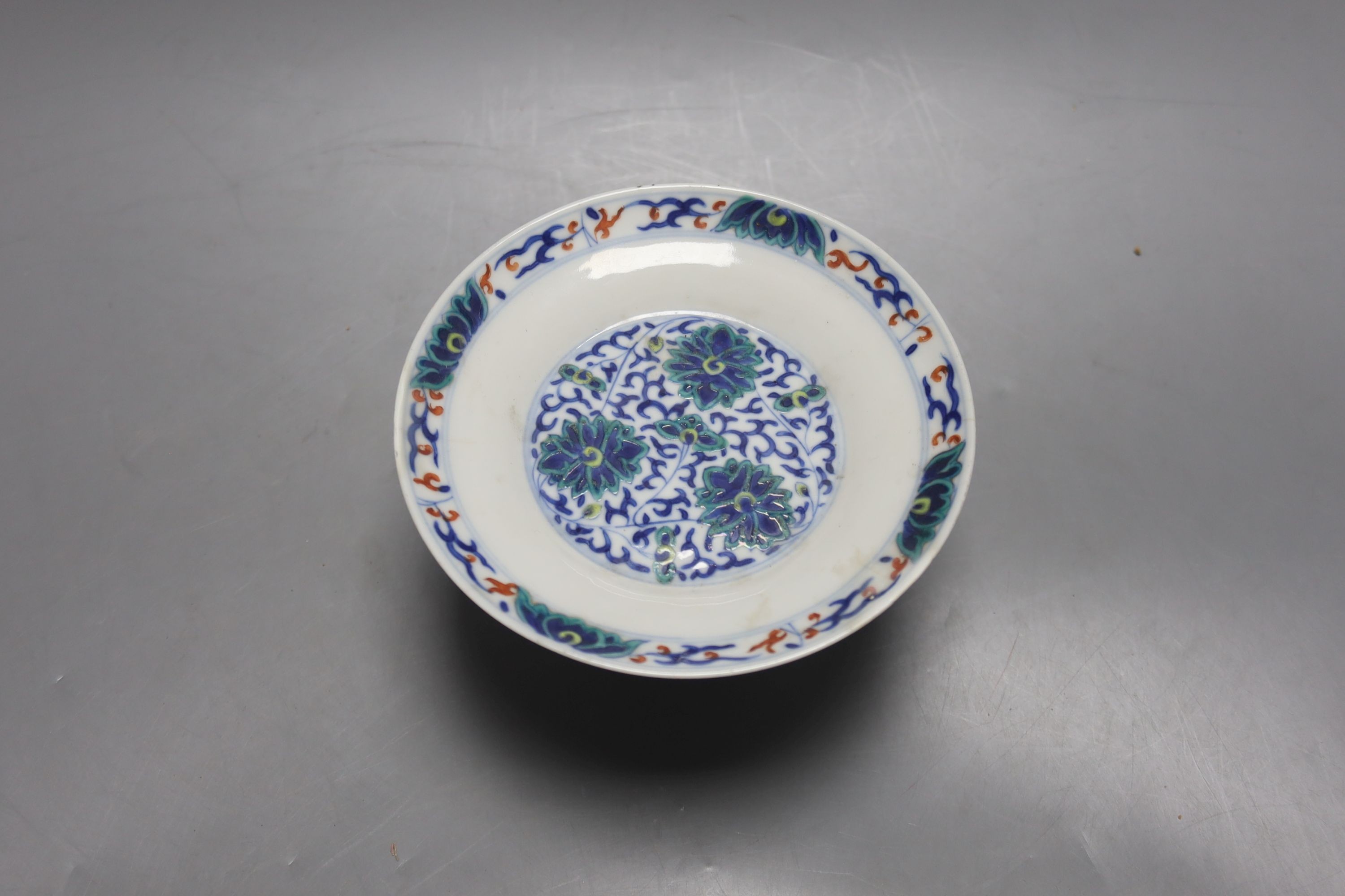 A Chinese blue and white water pipe vessel, a doucai stem dish and a Japanese Imari bowl, 19th century, (3)